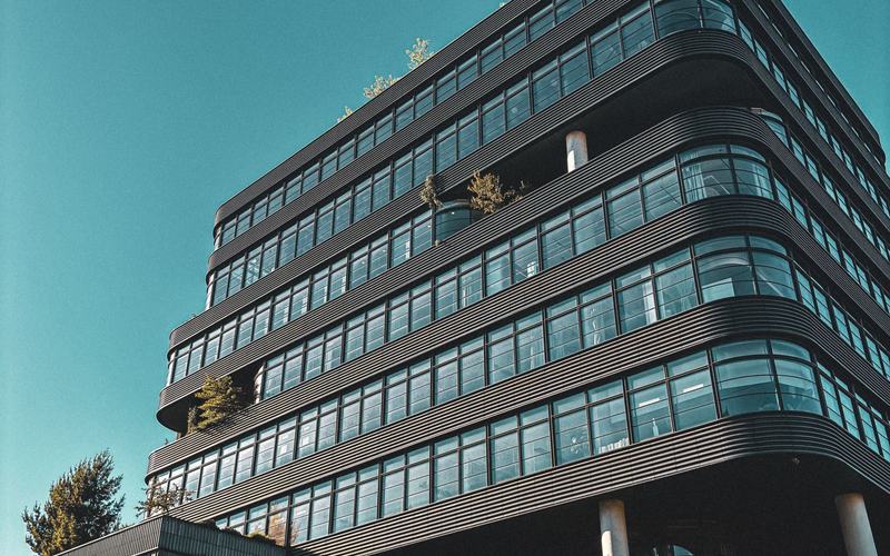 A modern commercial office building, the kind of income-producing property an investment loan is secured against