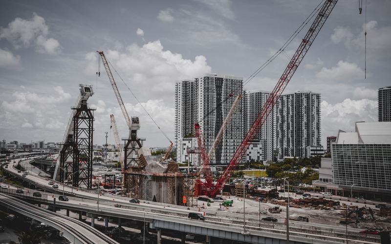 Cranes over a city development site at the pre-development stage